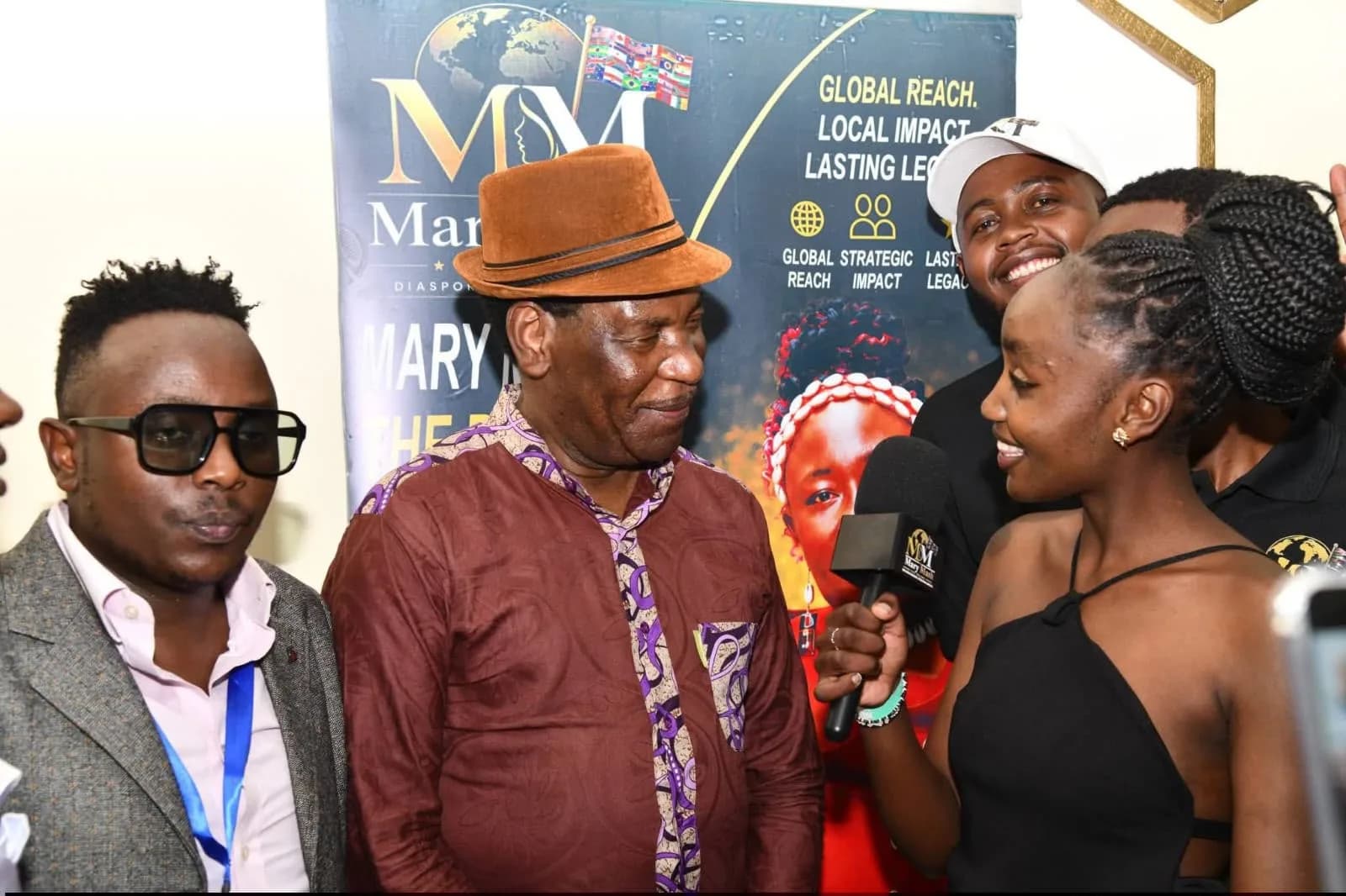 A Mary Mash TV reporter interviewing a guest in front of the Mary Mash banner
